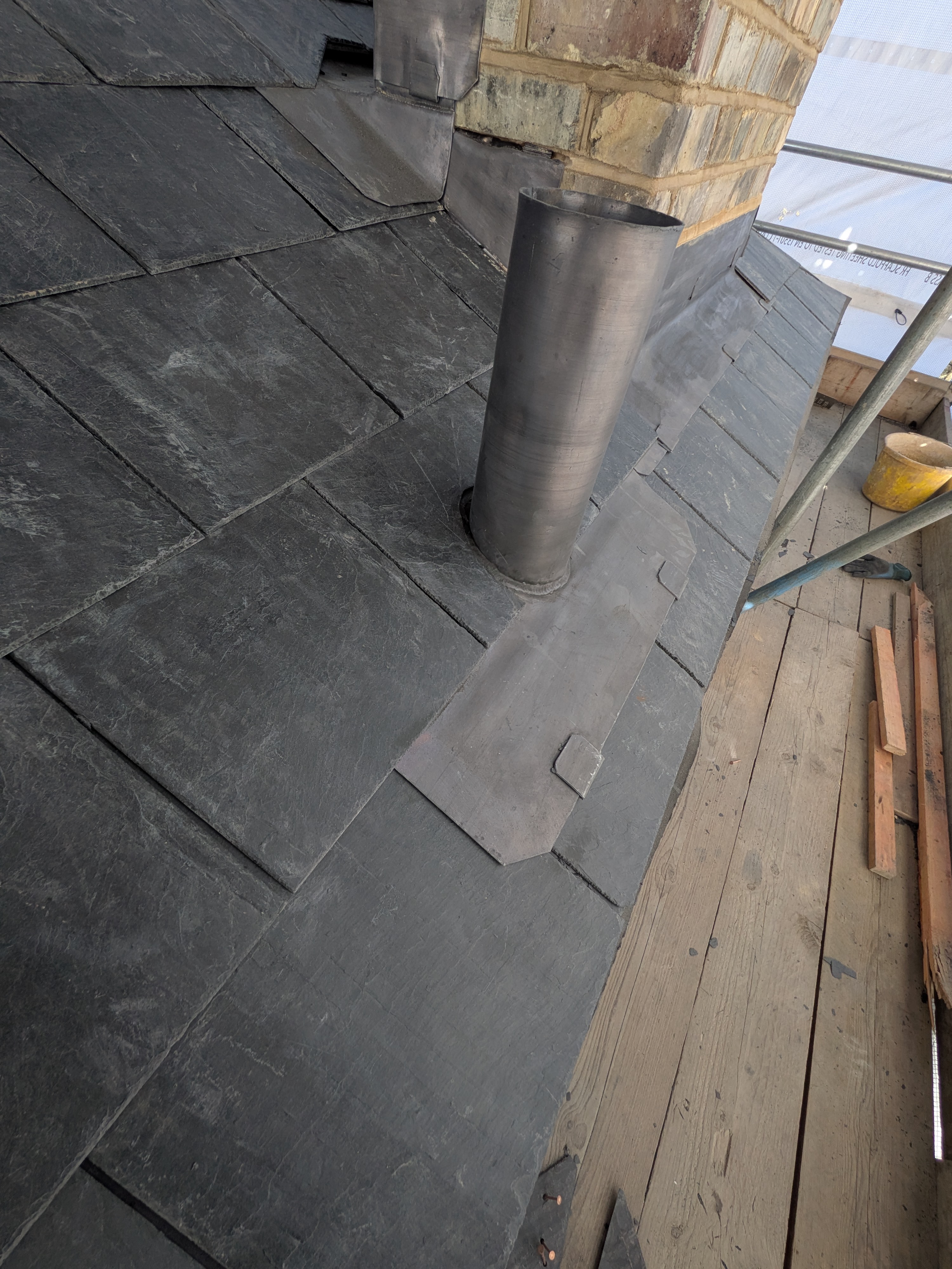 Detailed leadwork around a pipe on a slate roof